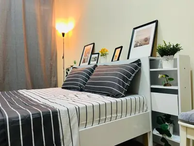a bedroom with a bed with black and white pillows at Beautiful Bedroom in Al Barsha Near Mashreq Metro in Dubai