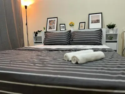 a bed with two towels laying on top of it at Beautiful Bedroom in Al Barsha Near Mashreq Metro in Dubai