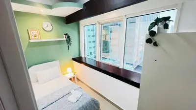 a small room with a bed and a window at Dreamy Partition Room in Barsha1 in Dubai
