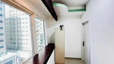 a hallway with a door and a large window at Dreamy Partition Room in Barsha1 in Dubai
