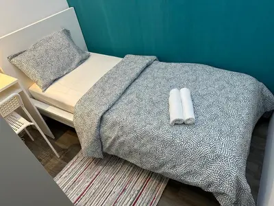 a bed with two white pillows on top of it at Epic Partition Room in Barsha Near Metro in Dubai