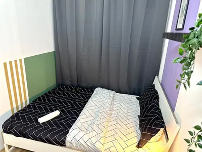 a small bed in a room with a curtain at Beautiful Double Partition Room in Tecom Near ICM Metro in Dubai