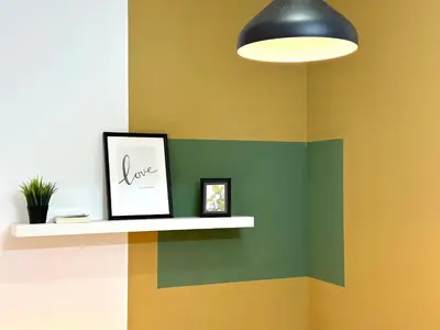 a wall with a shelf with a picture and a light at Budget Double Partition Room in Barsha Heights Near Metro in Dubai