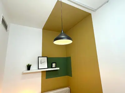 a room with yellow and green walls and a light fixture at Budget Double Partition Room in Barsha Heights Near Metro in Dubai