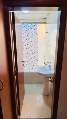 a bathroom with a sink and a shower at Budget Double Partition Room in Barsha Heights Near Metro in Dubai
