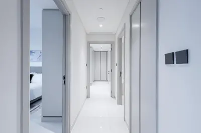 a hallway with white walls and a mirror at Seaside Serenity Perfect Beachfront Holiday Haven in Dubai