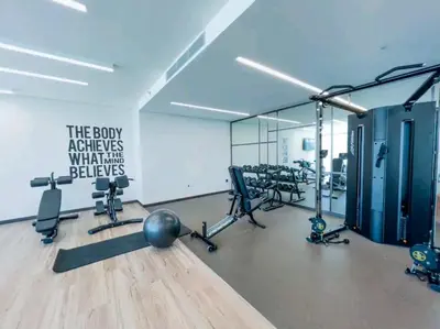 a room with a gym with exercise equipment in it at Seaside Serenity Perfect Beachfront Holiday Haven in Dubai
