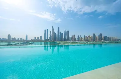 a large pool of water with a city in the background at Seaside Serenity Perfect Beachfront Holiday Haven in Dubai