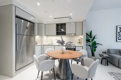a kitchen and dining room with a table and chairs at Seaside Serenity Perfect Beachfront Holiday Haven in Dubai