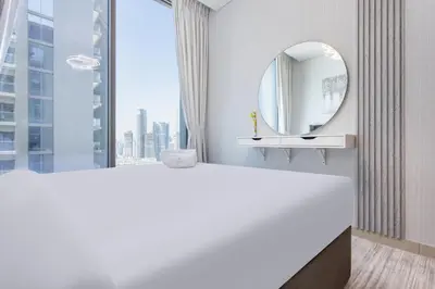 a white bathroom with a mirror and a sink at STAY BY LATINEM Luxury 1BR Holiday Home CVR B2704 near Burj Khalifa in Dubai