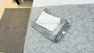 a black and white rug with a pillow on it at Fashion Partition Room Near Mall of The Emirates in Dubai