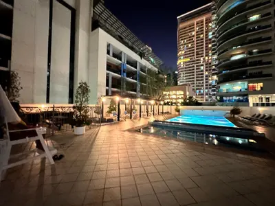 a pool in the middle of a city at night at Stay in heart of Dubai Marina Residence B walk to the JBR in Dubai