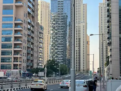 a busy city street with cars and tall buildings at Stay in heart of Dubai Marina Residence B walk to the JBR in Dubai