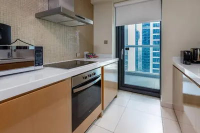 a kitchen with a sink and a stove at Paramount Towers - Elegant Home in Dubai