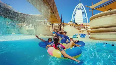 a group of people in the water at a resort at Brand new 2 Bedroom apartment in Madinat Jumeirah Living in Dubai