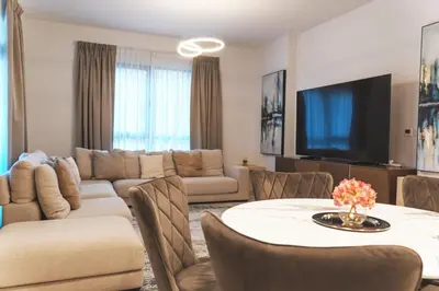 a living room with a couch and a table at New 2 bedroom entire apartment in Madinat Jumeirah Living in Dubai