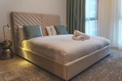 a large bed with a stuffed animal on top of it at New 2 bedroom entire apartment in Madinat Jumeirah Living in Dubai