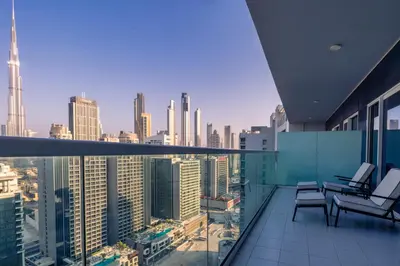 a balcony with chairs and a view of a city at Luxury Top Floor, with full Burj Khalifa View in Dubai