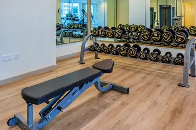 a gym with a row of treadmills and weights at Luxury Top Floor, with full Burj Khalifa View in Dubai