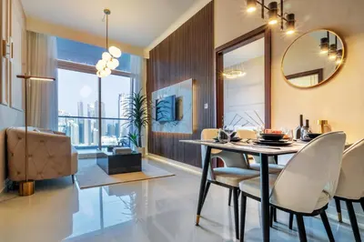 a dining room with a table and chairs and a mirror at Luxury Top Floor, with full Burj Khalifa View in Dubai