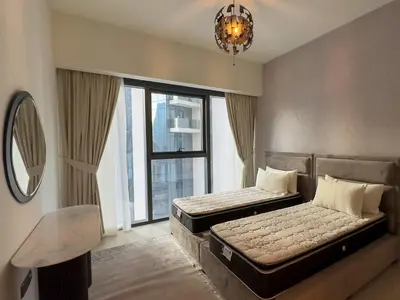 a bedroom with two beds and a large window at MH - Act One Act Two - 2BHK - REF503 in Dubai