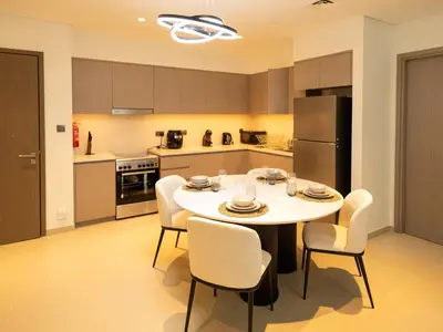 a kitchen with a table and chairs in a kitchen at MH - Act One Act Two - 2BHK - REF503 in Dubai