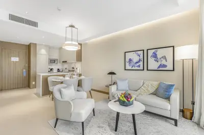a living room with a couch and chairs and a table at EDEN'S Homes & Villas - Address Opera District Residences in Dubai