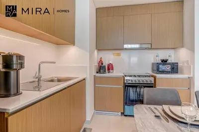 a small kitchen with a sink and a stove at Mira Holiday Homes - Fully furnished 1 bedroom in Creek Harbour in Dubai