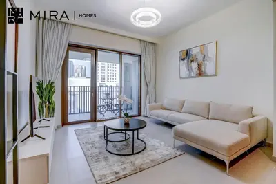a living room with a couch and a table at Mira Holiday Homes - Fully furnished 1 bedroom in Creek Harbour in Dubai
