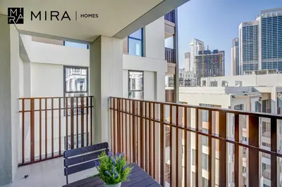 a balcony with a bench and a view of the city at Mira Holiday Homes - Fully furnished 1 bedroom in Creek Harbour in Dubai