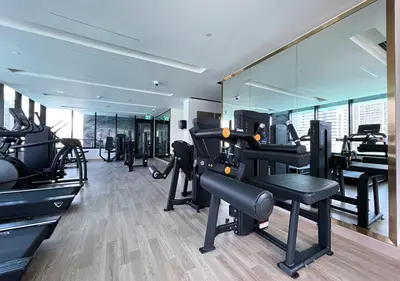 a gym with several treadmills and a large mirror at Lux Studio in Business Bay -10 mins to Burj Khalifa - Binghatti Canal in Dubai