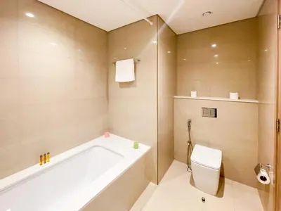 a bathroom with a tub and a toilet at Beautiful apartment by Dubai Mall 161BR-2 in Dubai