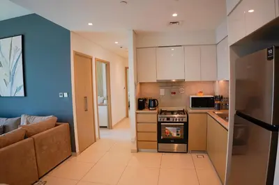 a kitchen with a couch and a stove top oven at Beautiful apartment by Dubai Mall 161BR-2 in Dubai
