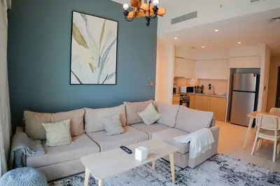 a living room with a couch and a table at Beautiful apartment by Dubai Mall 161BR-2 in Dubai
