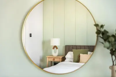 a mirror reflection of a bed in a room at GuestReady - Opulent Residence in Dubai Marina in Dubai