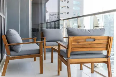 two chairs with pillows sitting on a balcony at Stylish Stayz beautiful modern apartment with Burj Khalifa views in Dubai