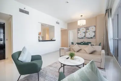 a living room with a couch and chairs and a table at Stylish Stayz beautiful modern apartment with Burj Khalifa views in Dubai