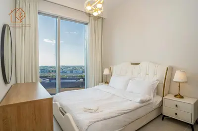 a bedroom with a white bed with a large window at Amazing One Bedroom Apartment in Downtown Dubai 167FO2-1 in Dubai