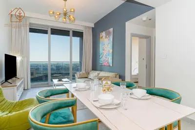 a dining room with a white table and green chairs at Amazing One Bedroom Apartment in Downtown Dubai 167FO2-1 in Dubai
