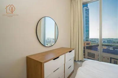 a bedroom with a mirror and a bed and a window at Amazing One Bedroom Apartment in Downtown Dubai 167FO2-1 in Dubai