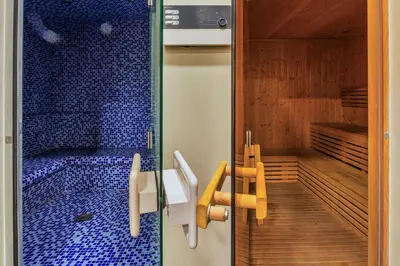 a room with a sauna with blue tiles on the wall at Luxury Top Floor apt with Full Burj Khalifa view in Dubai