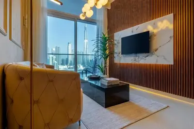 a living room with a couch and a large window at Luxury Top Floor apt with Full Burj Khalifa view in Dubai