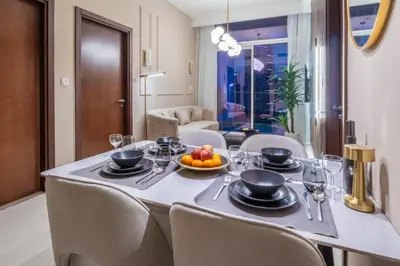 a dining room table with a bowl of fruit on it at Luxury Top Floor apt with Full Burj Khalifa view in Dubai