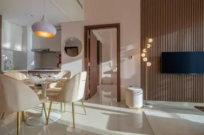 a dining room and kitchen with a table and chairs at Stylish Stayz 2BR Corner Unit - Yacht & Burj Khalifa Views - close to Dubai Mall in Dubai