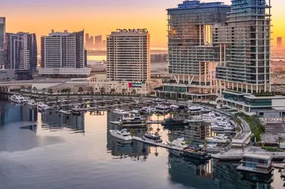 a group of boats docked in a marina in a city at Stylish Stayz 2BR Corner Unit - Yacht & Burj Khalifa Views - close to Dubai Mall in Dubai