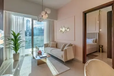 a living room with a couch and a bed at Stylish Stayz 2BR Corner Unit - Yacht & Burj Khalifa Views - close to Dubai Mall in Dubai