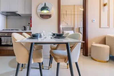 a dining room table and chairs in a kitchen at Stylish high floor apartment with Burj View in Dubai