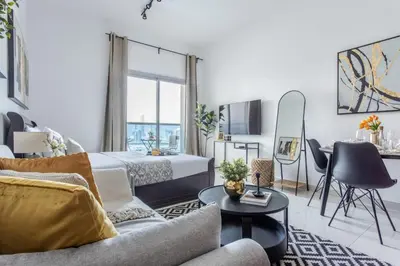 a bedroom with a bed and a couch and a table at Frank Porter - Elite 5 Sports Residence in Dubai