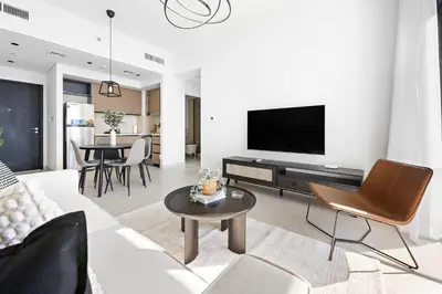 a living room with a couch and a tv at Silkhaus Upscale 1BR by Burj Khalifa with Balcony in Dubai