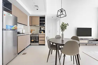 a kitchen and dining room with a table and chairs at Silkhaus Upscale 1BR by Burj Khalifa with Balcony in Dubai
